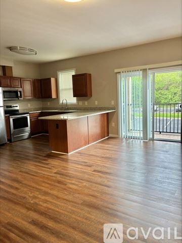 Cincinnati apartment for rent - A kitchen with wooden cabinets and a wooden floor.