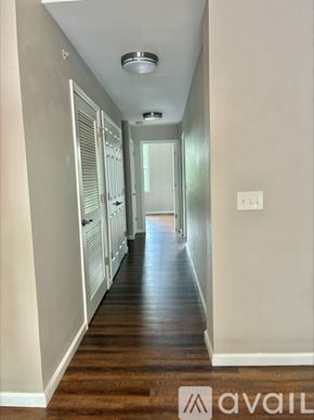 Cincinnati apartment for rent - A long hallway with a light on the ceiling and a door at the end.
