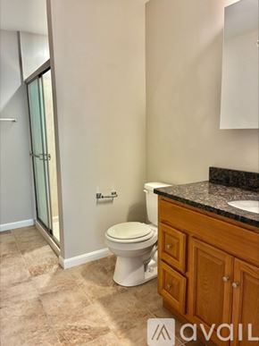 Cincinnati apartment for rent - A bathroom with a toilet, sink, and a cabinet.