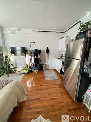 Boston apartment for rent - A kitchen with a refrigerator, a sink, and a dining table.