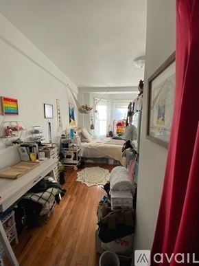 Boston apartment for rent - A room with a bed, desk, and a hammock.