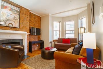 Boston apartment for rent - A living room with a fireplace and a painting on the wall.