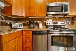 Boston apartment for rent - A kitchen with wooden cabinets and a stainless steel oven.