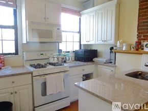 Boston apartment for rent - A kitchen with white appliances and cabinets.