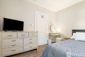 Gulfport house for rent - A bedroom with a large bed and a window.
