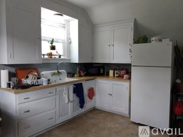 Mankato apartment for rent - A kitchen with white cabinets and a window above the stove.