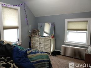 Mankato apartment for rent - A bedroom with a bed, dresser, and window.