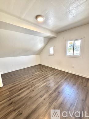 Los Angeles house for rent - A room with wooden flooring and a window.