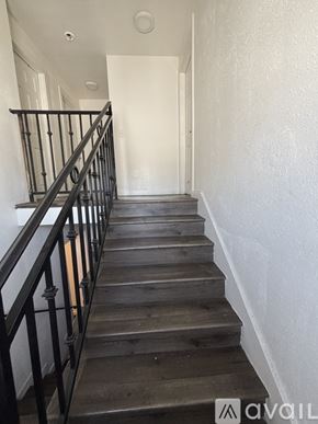 Los Angeles house for rent - A staircase with wooden steps and black railings.