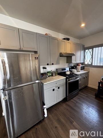 Los Angeles house for rent - A kitchen with a stainless steel refrigerator and wooden floors.