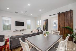 Houston townhouse for rent - A modern dining room with a wooden table and chairs.