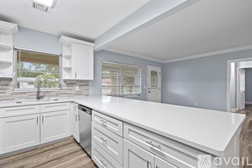 Belleair Bluffs house for rent - A kitchen with white cabinets and a white countertop.