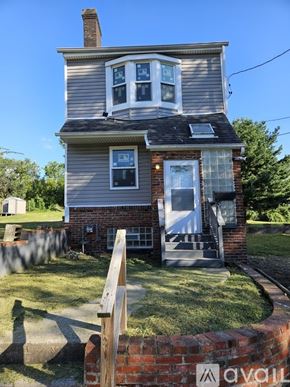 Pittsburgh house for rent - A house with a grey roof and a white door.