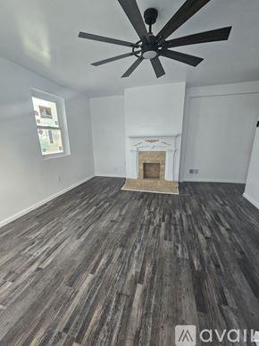 Pittsburgh house for rent - A room with a fireplace and wood flooring.