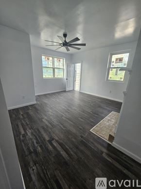 Pittsburgh house for rent - A room with a ceiling fan and wood flooring.