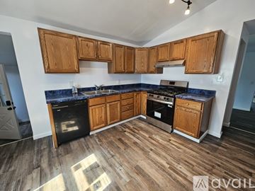 Pittsburgh house for rent - A kitchen with wooden cabinets and a blue countertop.