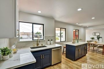San Leandro house for rent - A modern kitchen with dark blue cabinets and a white countertop.