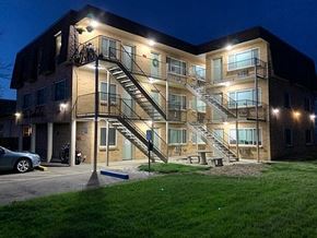 Englewood apartment for rent - A building with a lit up staircase in front of it.