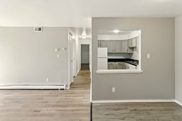 Merrillville apartment for rent - A kitchen area with a white refrigerator and wooden flooring.