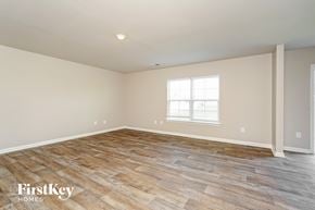 Lexington house for rent - A room with wooden flooring and a window with blinds.