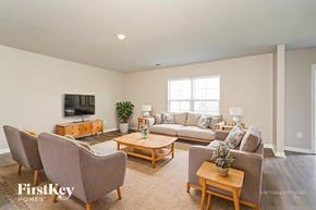 Lexington house for rent - A living room with a couch, chairs, and a television.