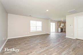 Lexington house for rent - A spacious room with wooden flooring and a large window.