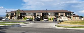 Powell apartment for rent - A large building with a parking lot in front of it.
