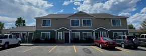Cody apartment for rent - A building with a parking lot in front of it.