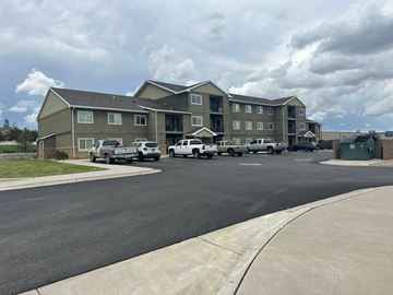 Casper apartment for rent - A large apartment complex with a parking lot in front.