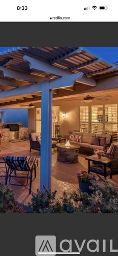 Sun City West house for rent - A patio with a table and chairs is set up outside a house.