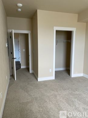 Missoula apartment for rent - A room with a carpeted floor and a doorway leading to another room.