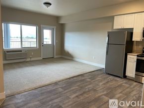 Missoula apartment for rent - A kitchen area with a refrigerator, oven, and cabinets.