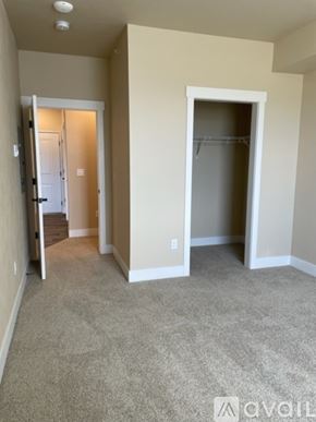 Missoula apartment for rent - A room with a carpeted floor and two open doors.