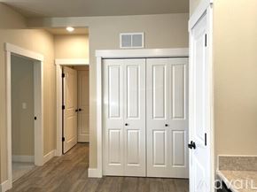 Missoula apartment for rent - A white double door closet with a white door to the left and a white door to the right.