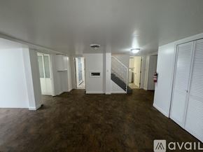 Malden apartment for rent - A spacious room with wooden flooring and white walls.