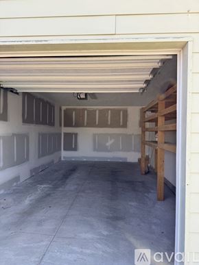 Dayton apartment for rent - A garage with a white wall and a wooden support beam.