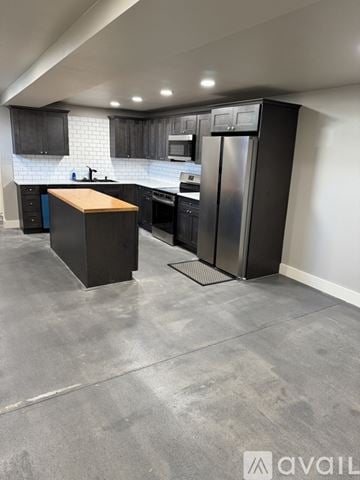 Dayton apartment for rent - A modern kitchen with a wooden island and stainless steel appliances.