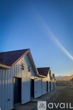 Palmer apartment for rent - A series of white buildings with dark roofs are lined up in a row.