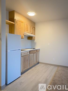 Palmer apartment for rent - A kitchen with wooden cabinets and a white refrigerator.