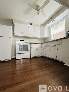 Chicago apartment for rent - A kitchen with white appliances and cabinets.
