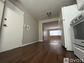 Chicago apartment for rent - A kitchen with white appliances and wooden floors.