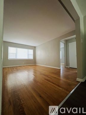 Chicago apartment for rent - A room with wooden floors and a window.