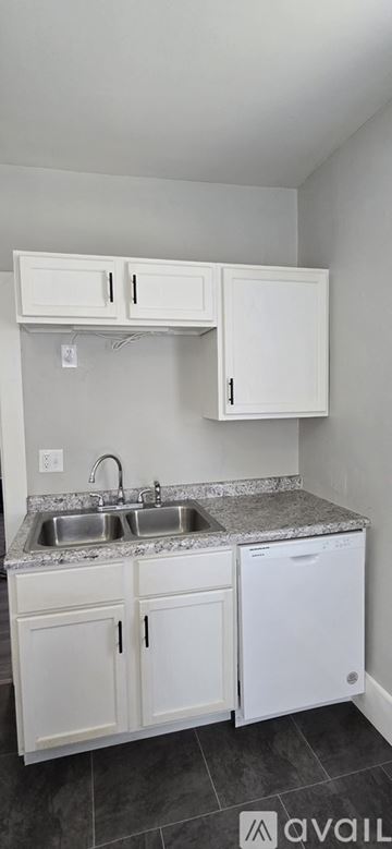 Bloomington apartment for rent - A kitchen with white cabinets and a granite countertop.