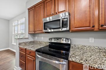 Morrisville house for rent - A kitchen with wooden cabinets and granite countertops.
