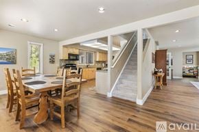 Breckenridge house for rent - A bedroom with two bunk beds and a single bed with a striped comforter.