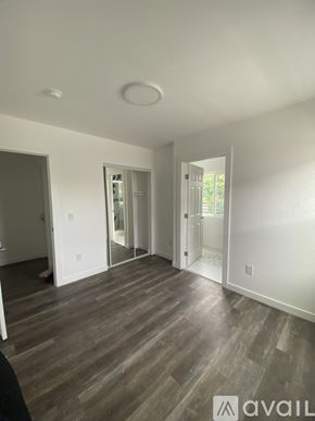 Los Angeles apartment for rent - A room with wooden floors and white walls.