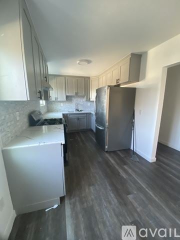 Los Angeles apartment for rent - A kitchen with a refrigerator, sink, and cabinets.