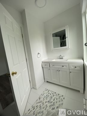 Los Angeles apartment for rent - A bathroom with a white sink and a mirror above it.