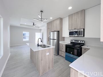 Edinburg apartment for rent - A modern kitchen with a blue oven and a white countertop.