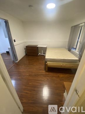 Boston apartment for rent - A bedroom with a bed, dresser, and window.
